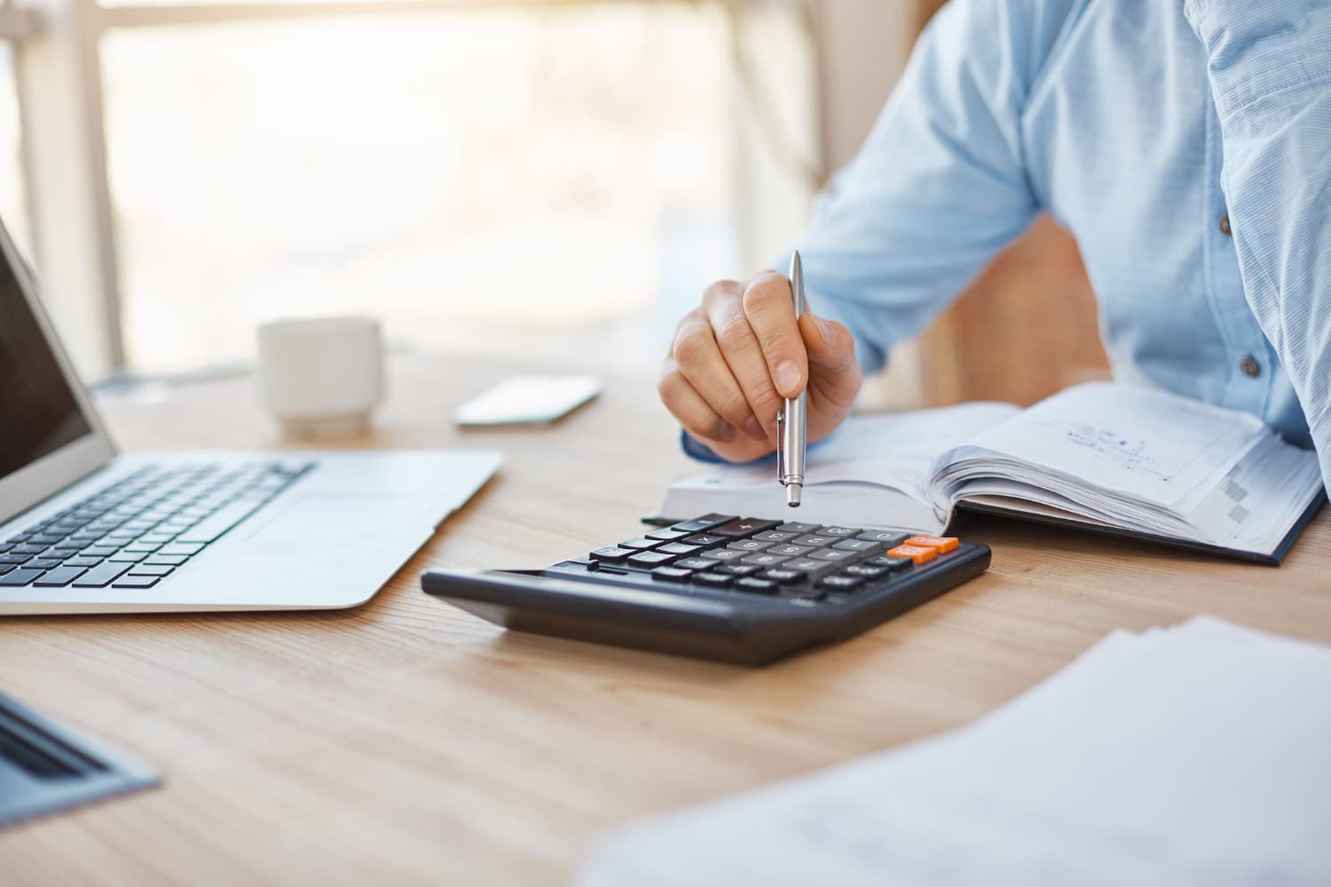 Person reviewing financial documents at a desk