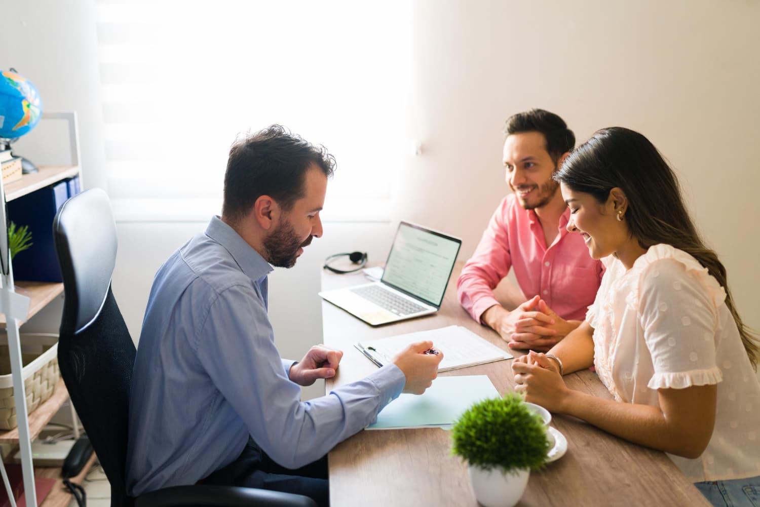 Financial advisor meeting with clients at a table