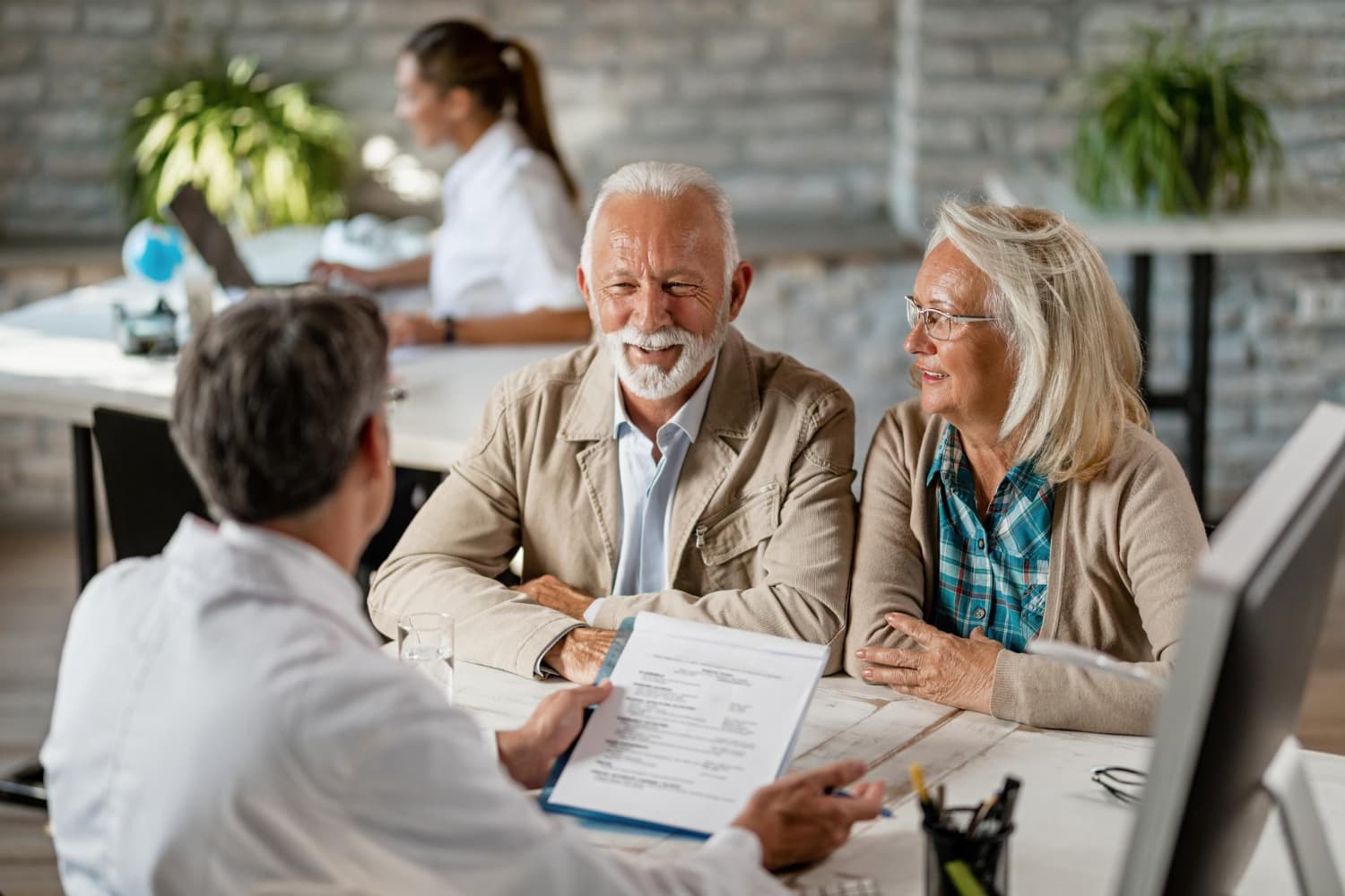 Older couple reviewing life insurance policy with an advisor