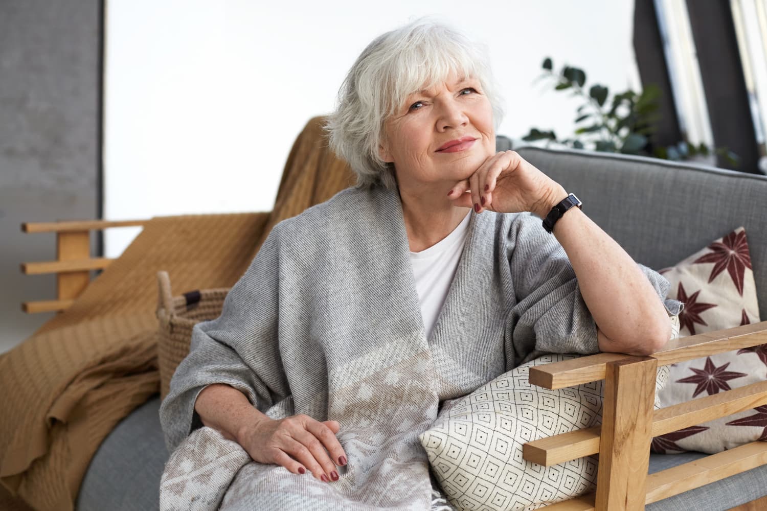 Woman relaxing confidently at home — retirement years